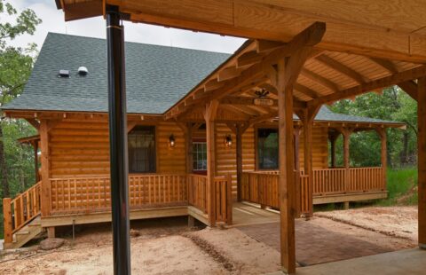 The image features a beautifully crafted log cabin complete with a welcoming porch.