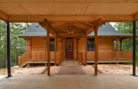 The image showcases a beautifully crafted front porch of one of our stunning log cabins.