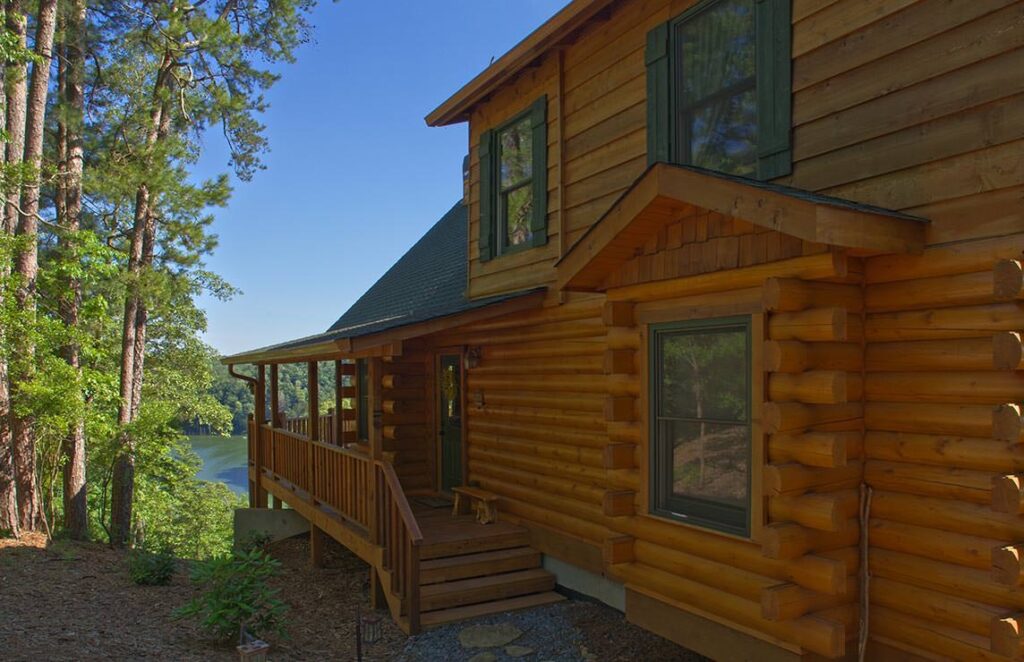 The image showcases one of our beautifully crafted log cabins, perfectly nestled on the serene edge of a picturesque lake.