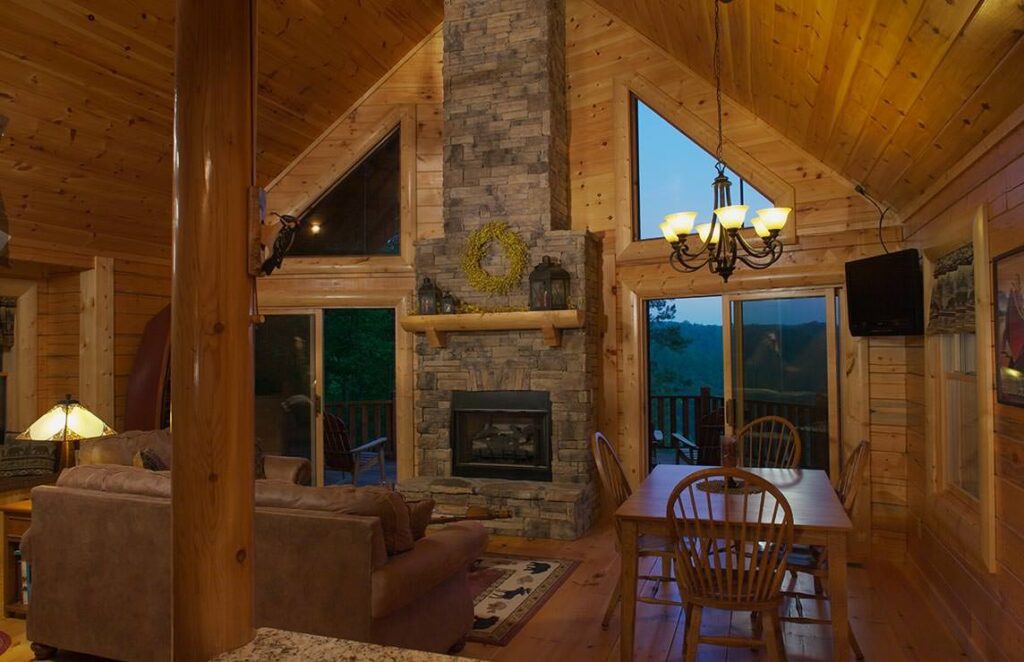 The image showcases a warm and inviting living room inside a beautifully crafted log cabin, highlighted by a cozy fireplace.