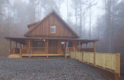 Our log home is nestled amidst lush woodland, offering a picturesque view enhanced by ethereal fog.