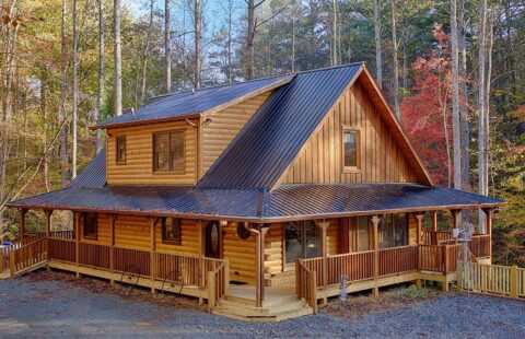 Our latest log cabin design features a sturdy metal roof, nestled amidst a serene woodland setting.