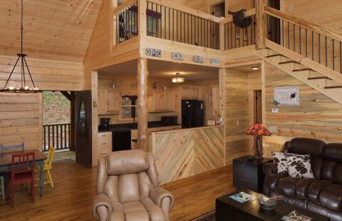 The image showcases a warm and cozy living room alongside a charming dining area, exemplifying rustic elegance, nestled within one of our high-quality log cabins.