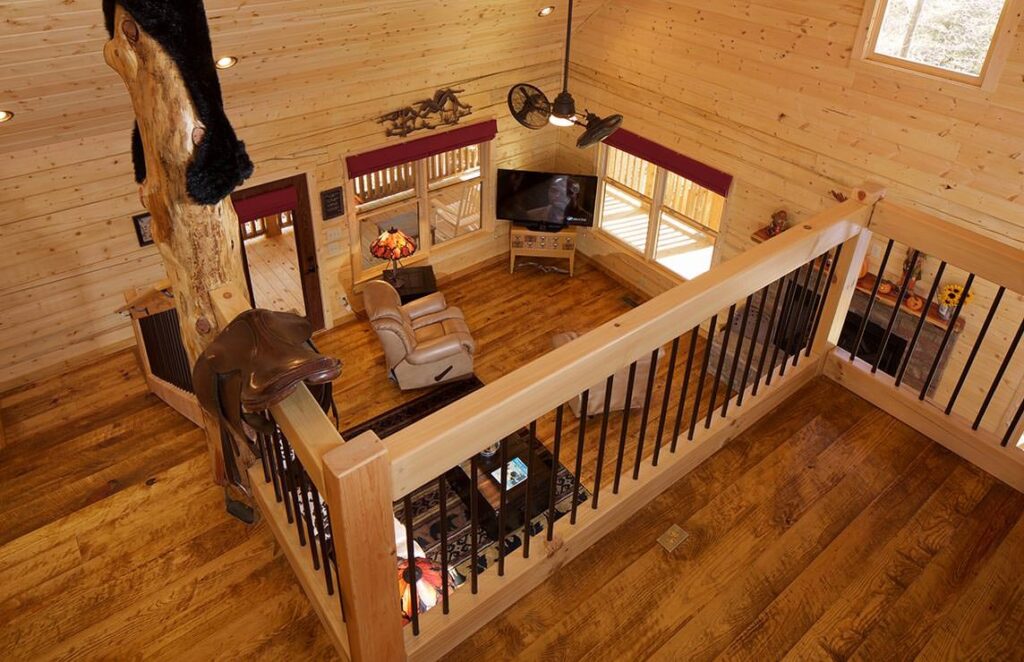 The image showcases a cozy and inviting living room within one of our beautifully crafted log cabins.