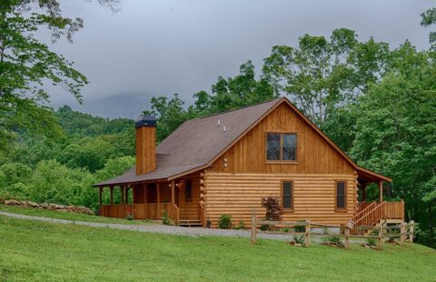 Our beautifully crafted log cabin nestles gently on a hill amidst a tranquil, wooded landscape.