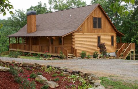 The image depicts a beautifully crafted log cabin nestled within the tranquility of a lush woodland setting.