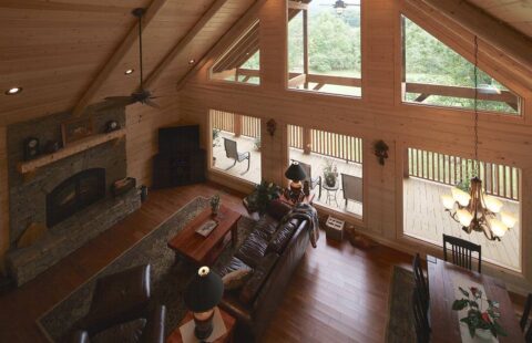 The image showcases a cozy, rustic living room within one of our high-quality log cabins, elegantly furnished to create a warm and inviting atmosphere.