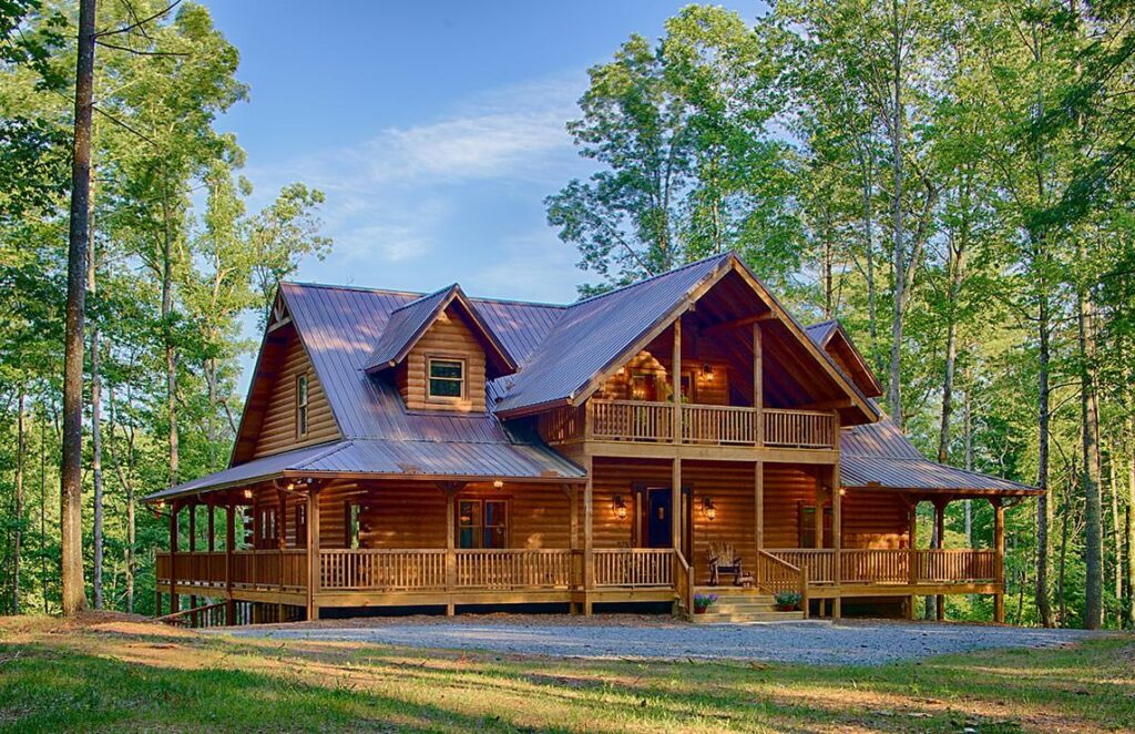 The image depicts a beautifully crafted log home nestled in the serenity of a lush woodland.