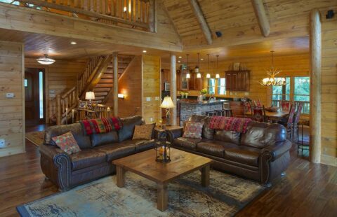 The image showcases a cozy and inviting living room inside one of our beautifully crafted log cabins.
