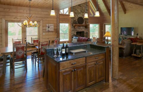 The image showcases an inviting kitchen situated inside one of our beautifully crafted log homes featuring rustic design elements.
