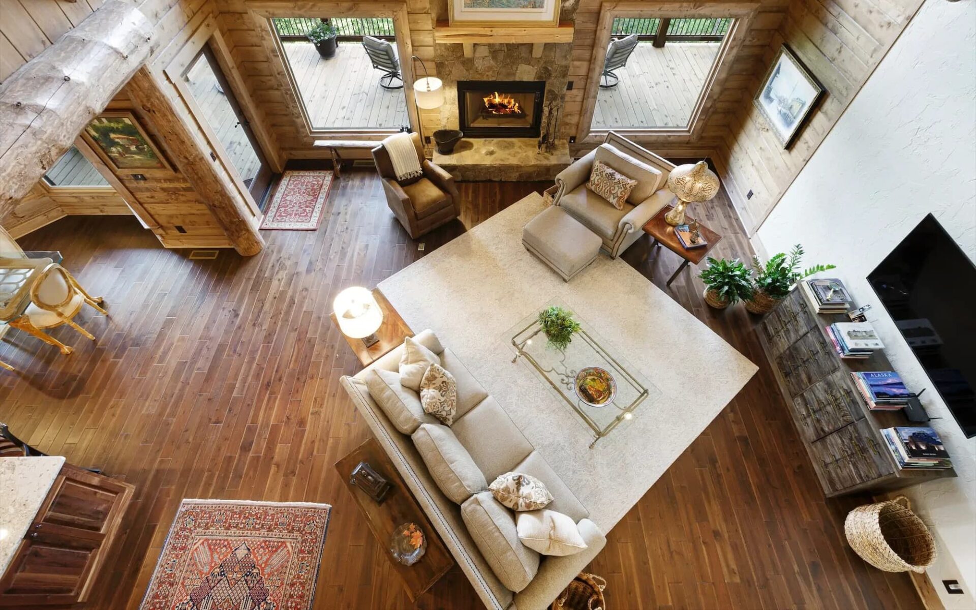 The image showcases a top-down perspective of a cozy, spacious living room within one of our beautifully crafted log homes.