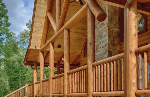 A rustic, inviting front porch of a beautifully constructed log cabin shows off our company’s craftsmanship and attention to detail.