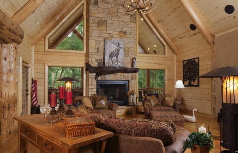 The image showcases a cozy and inviting living room beautifully crafted within our log cabin home.