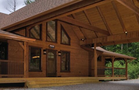 Our product is a beautifully crafted log cabin featuring a cozy covered porch.