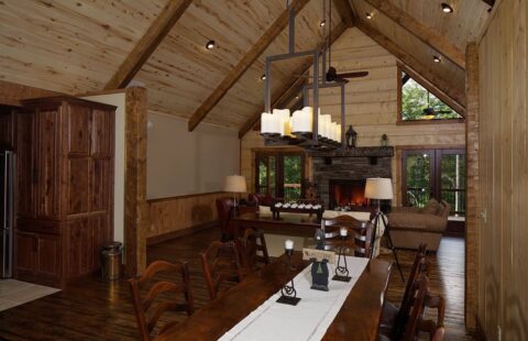 The image showcases a beautifully designed, cozy dining and living room set within the rustic charm of our log cabin home.