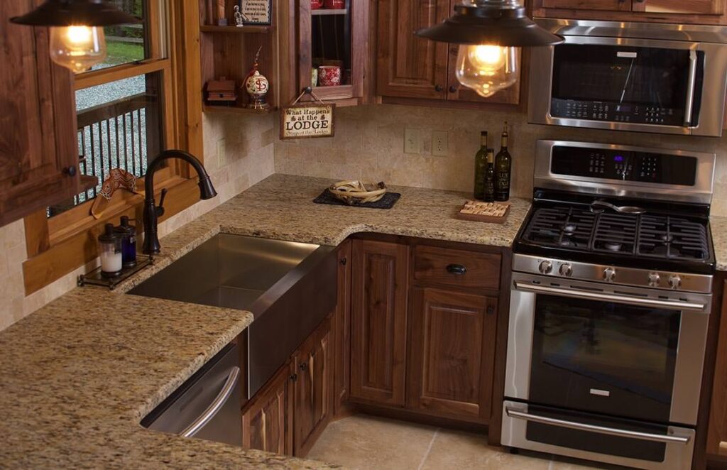 The image showcases a beautifully crafted kitchen featuring our high-quality wooden cabinets and an integrated stove, reflecting the warm, rustic charm of our log homes.