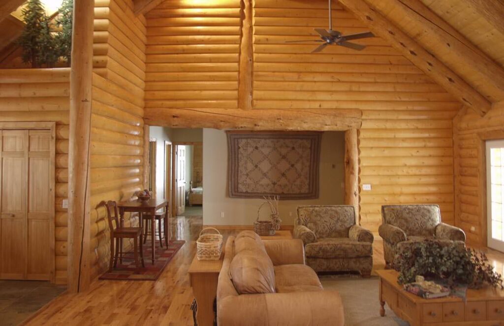 The image showcases a cozy and rustic living room within one of our expertly crafted log cabins.